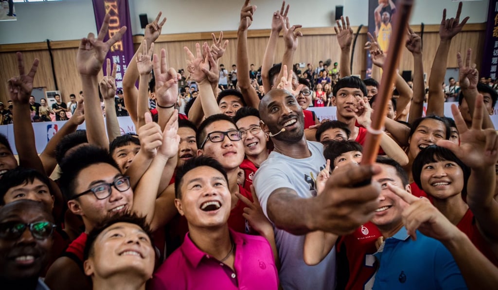 Kobe Bryant takes a selfie with fans at Mission Hills Haikou. Photo: Mission Hills Kobe Bryant takes a selfie with fans at Mission Hills Haikou. Photo: Mission Hills
