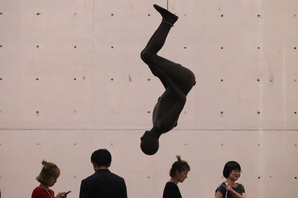 Some sculptures hang from the ceiling, bound at the ankles. Photo: Simon Song
