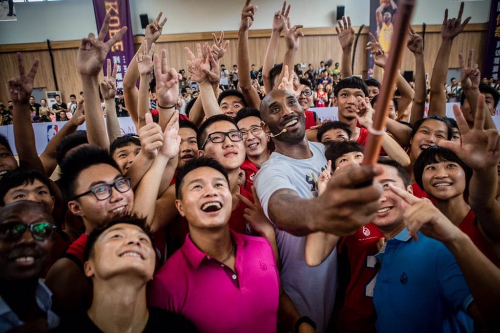 Bryant poses for a group selfie after a basketball clinic at the Overseas Chinese Mission Hills School. Photo: Mission Hills Bryant poses for a group selfie after a basketball clinic at the Overseas Chinese Mission Hills School. Photo: Mission Hills