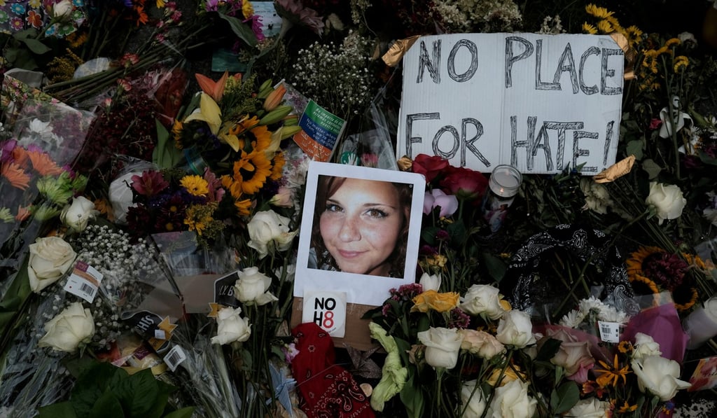 A photograph of Charlottesville victim Heather Heyer is seen amongst flowers left at the scene of the car attack on a group of counter-protesters during the Unite the Right in Charlottesville, Virginia, on August 14. Photo: Reuters