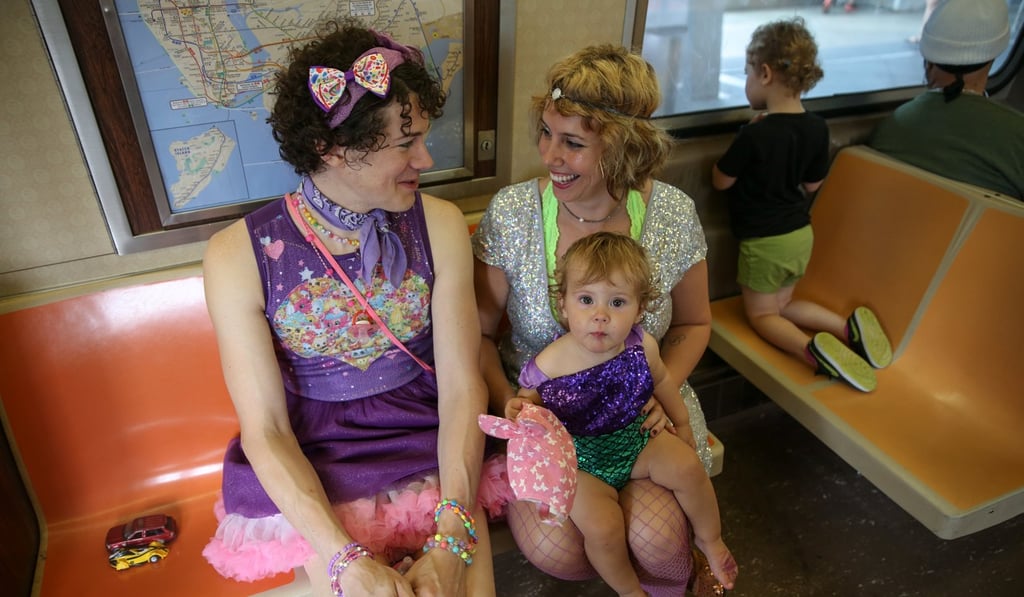 A family rides the subway to take part in the Poseidon's Parade in Queens, New York. Photo: Reuters
