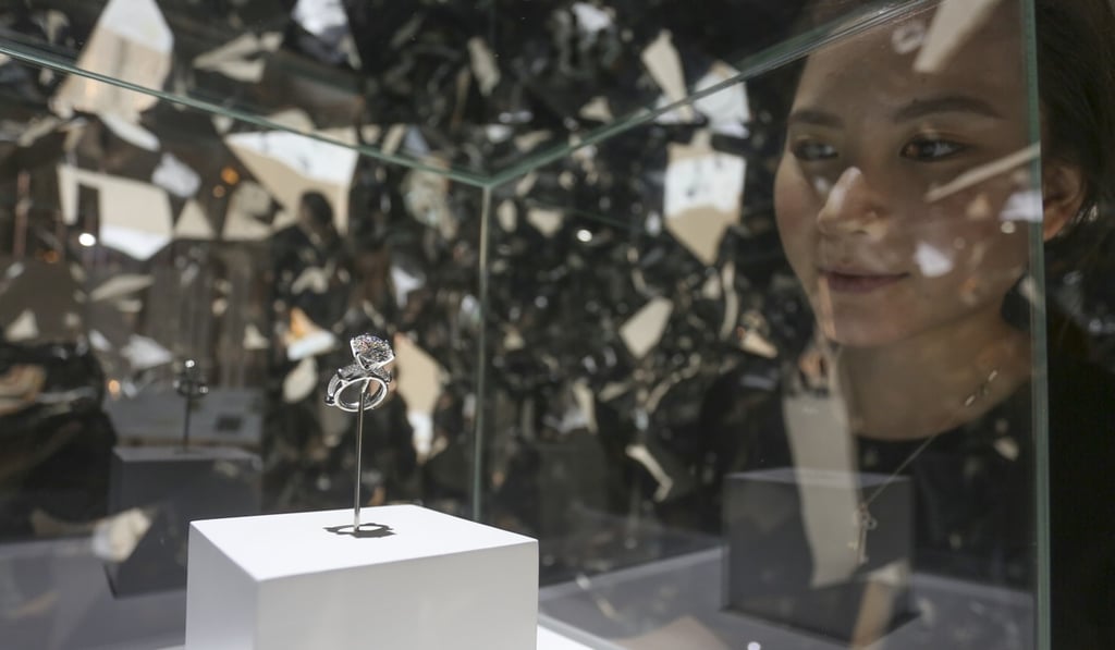 A woman looks at an 8.8 carat diamond ring, the new limited anniversary edition Pava, the Tiffany Setting Diamond Engagement Ring, on display at the 130th anniversary of the Tiffany exhibition in Hong Kong. SCMP / May Tse