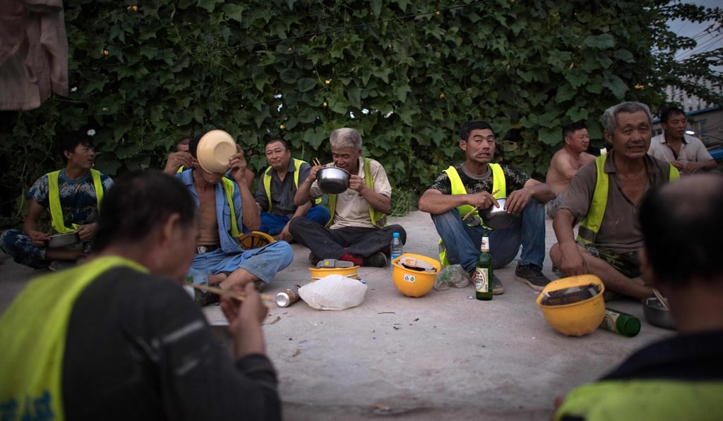 Construction workers eat their dinner at the end of a work day. Photo: AFP