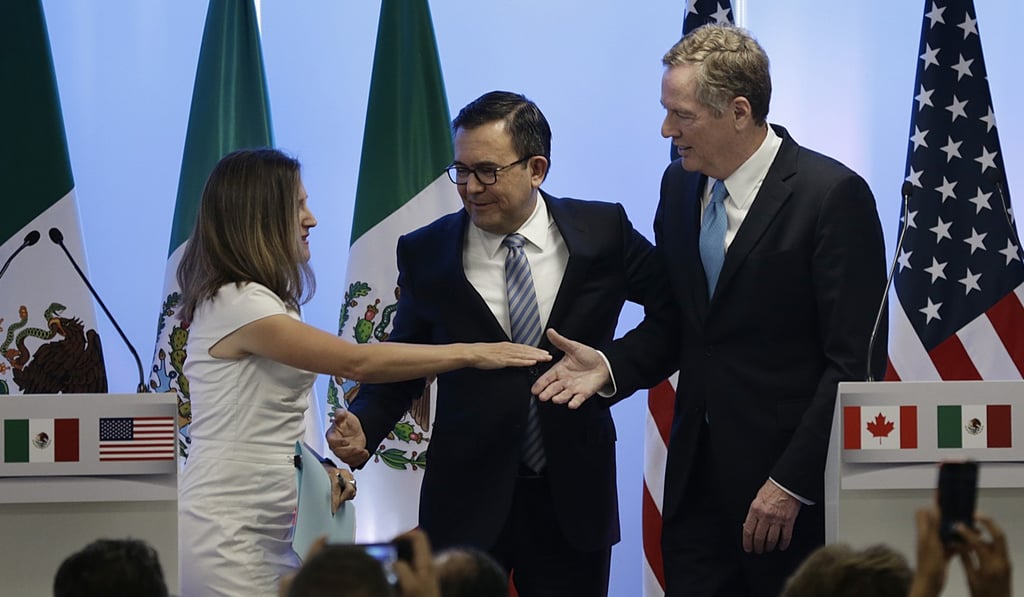 Canada's Foreign Minister Chrystia Freeland, left, Mexico's Economy Secretary Ildefonso Guajardo Villarreal, centre, and US Trade Representative Robert Lighthizer shake hands after posing for a group photo at a press conference regarding the second round of Nafta renegotiations in Mexico City. Photo: AP Canada's Foreign Minister Chrystia Freeland, left, Mexico's Economy Secretary Ildefonso Guajardo Villarreal, centre, and US Trade Representative Robert Lighthizer shake hands after posing for a group photo at a press conference regarding the second round of Nafta renegotiations in Mexico City. Photo: AP