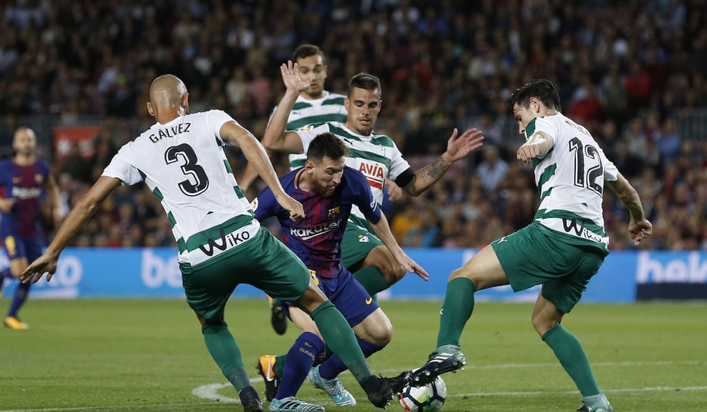 Barcelona forward Lionel Messi (C) battles for the ball with Eibar players during the Spanish league football match in Barcelona on September 19, 2017. Photo: AFP