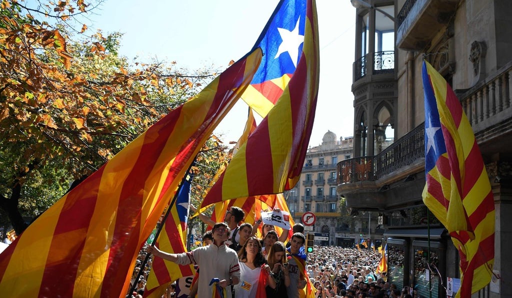 People wave Catalan pro-independence flags during a protest at the entrance of Catalonia’s regional government economy headquarters in Barcelona. Photo: AFP People wave Catalan pro-independence flags during a protest at the entrance of Catalonia’s regional government economy headquarters in Barcelona. Photo: AFP