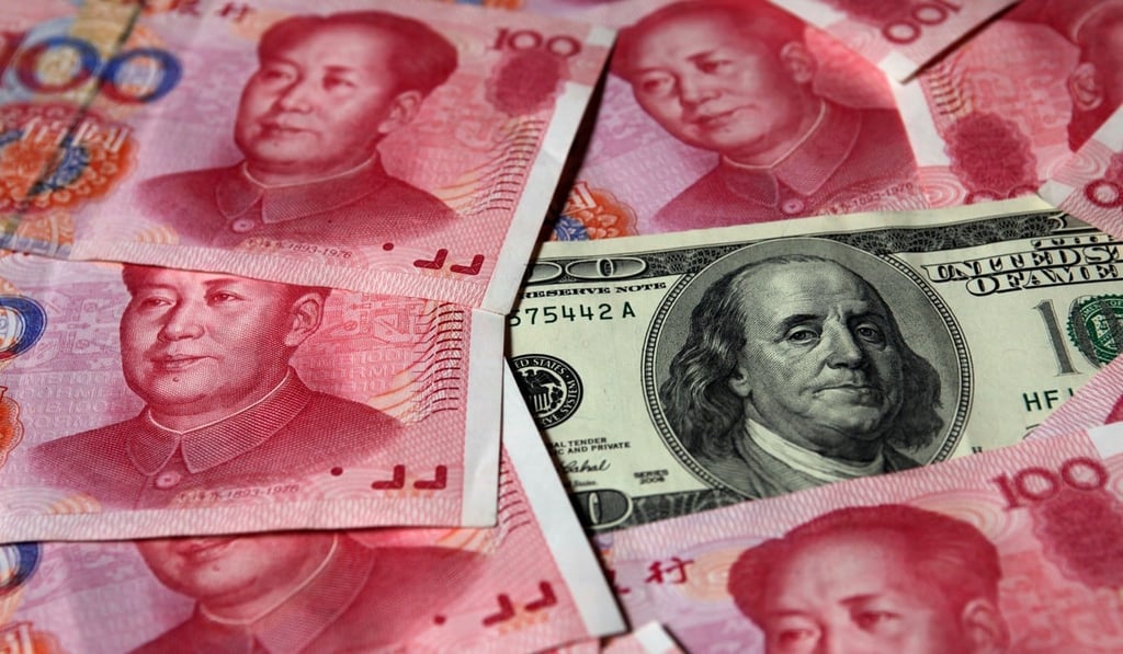 A US$100 banknote placed next to 100 yuan banknote. Photo: Reuters