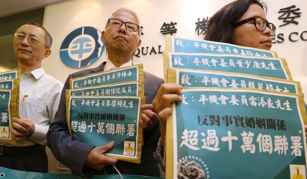 Choi Chi-sum (centre), general secretary of the Society for Truth and Light, and other members of the conservative Christian group present more than 100,000 signatures to the Equal Opportunities Commission to oppose its move to redefine marital status, on October 28, 2014. Photo: Nora Tam