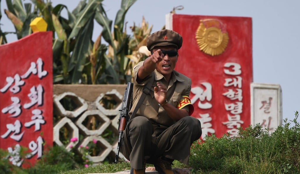 A North Korean soldier reacts as tourists pass by in a boat near the North Korean town of Sinuiju, opposite the Chinese border city of Dandong. Photo: AFP A North Korean soldier reacts as tourists pass by in a boat near the North Korean town of Sinuiju, opposite the Chinese border city of Dandong. Photo: AFP