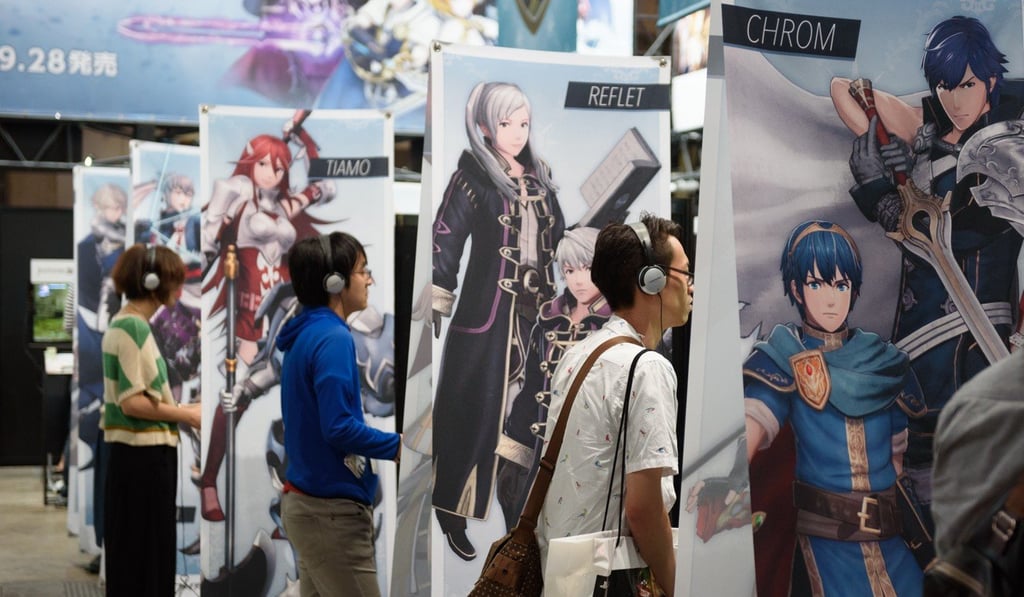 Show attendees play Fire Emblem Warriors at the Koei Tecmo booth. Photo: Bloomberg