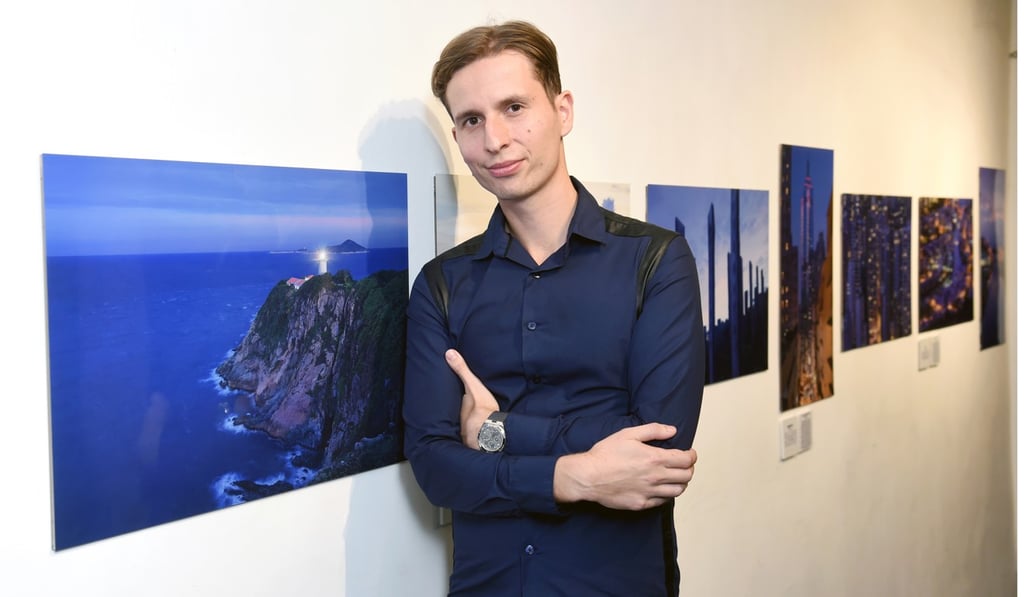 Photographer Romain Jacquet-Lagrèze with his ‘blue-hour images of Hong Kong at the exhibition.