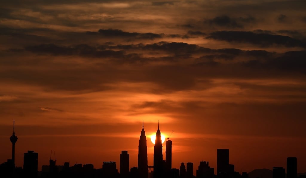 Malaysia's landmark Petronas Twin towers are silhouetted as the sun sets over the Kuala Lumpur skyline. Photo: AFP Photo