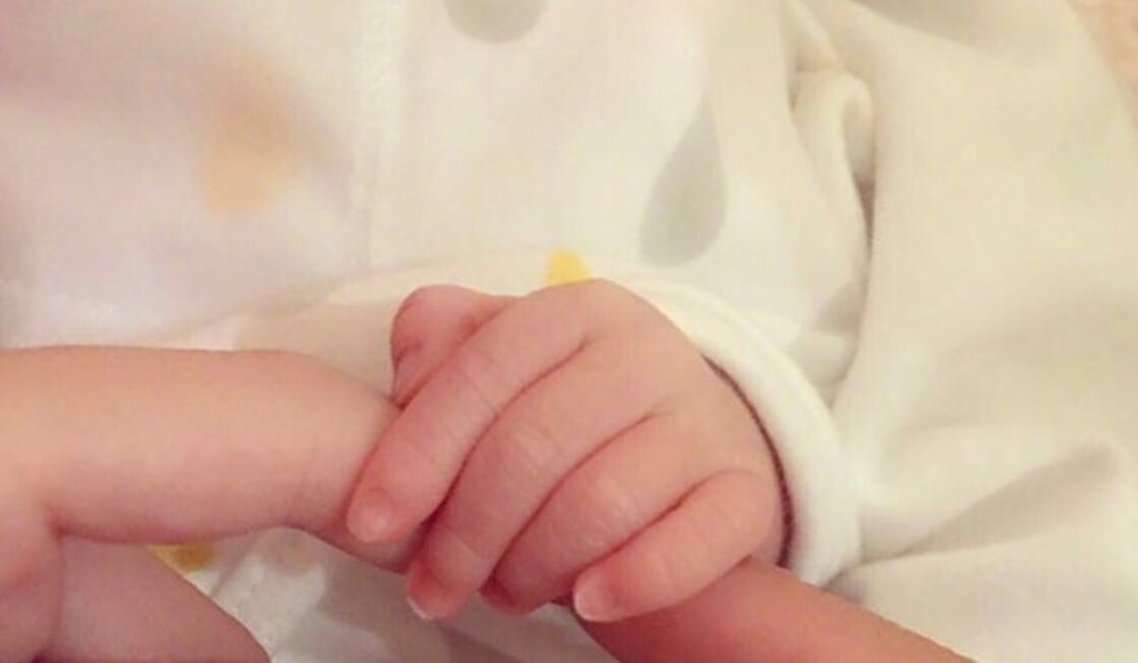 The photo Aaron Kwok posted on social media, showing the baby’s hand grasping its parents’ fingers. Photo: Weibo
