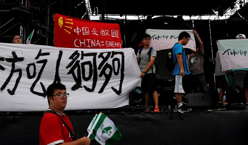 Protestors with anti-mainland China banners at the concert. Photo: Reuters