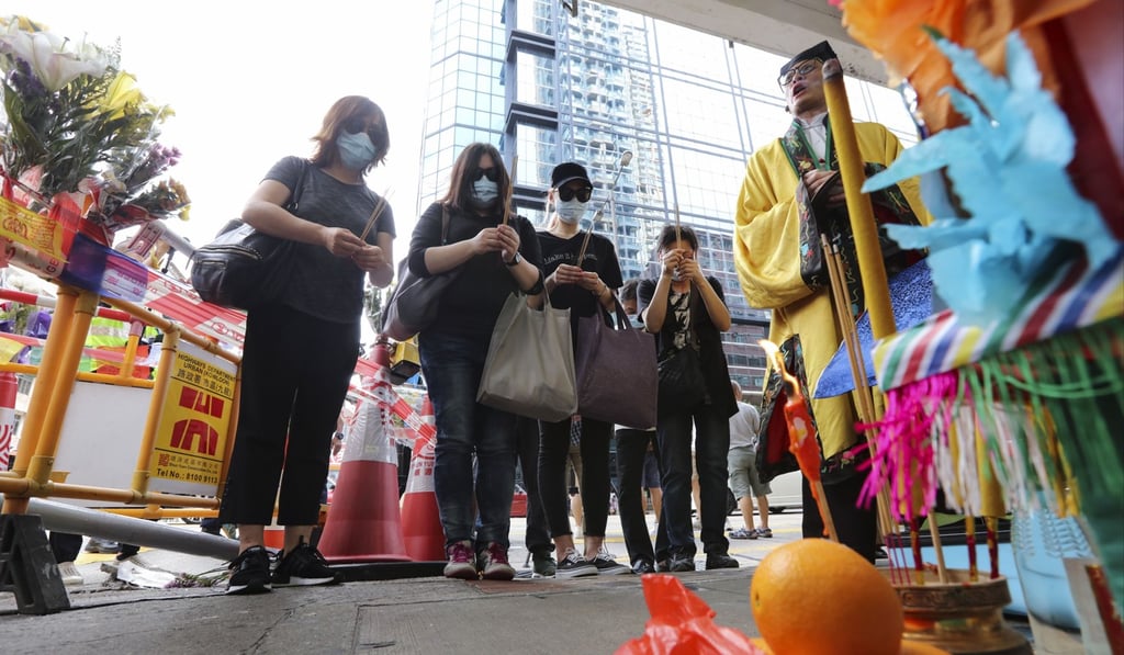 Relatives of victims involved in Friday’s bus crash attend a ritual ceremony on Yen Chow Street in Sham Shui Po. Photo: Felix Wong
