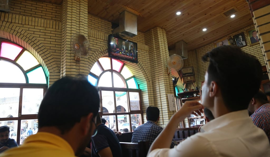 People in Iraqi Kurdistan watch as the results of the independence referendum are announced. The vote, which was condemned by neighbouring nations, has prompted airlines to cease flights to the region. Photo: EPA