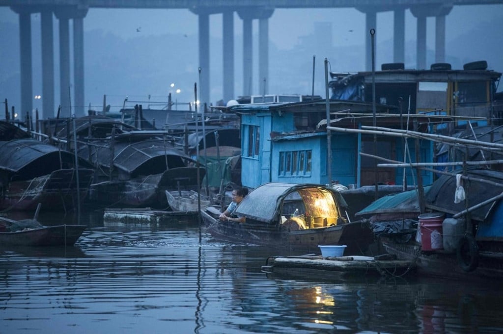 A woman on her boat after waking up in Datang. Photo: AFP A woman on her boat after waking up in Datang. Photo: AFP