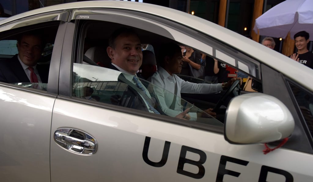 US Ambassador Willam Heidt, front seat, and Uber's Asia Pacific chief business officer Brooks Entwistle, back seat, sit in a Uber car travelling along a street in Phnom Penh. US-based Uber, the world’s biggest ride-hailing service, makes its debut in the capital Phnom Penh on September 28. Photo: AFP US Ambassador Willam Heidt, front seat, and Uber's Asia Pacific chief business officer Brooks Entwistle, back seat, sit in a Uber car travelling along a street in Phnom Penh. US-based Uber, the world’s biggest ride-hailing service, makes its debut in the capital Phnom Penh on September 28. Photo: AFP