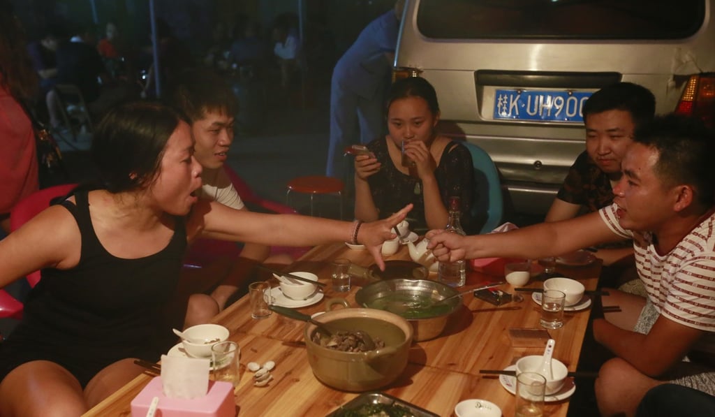 Dining on dog meat in Yulin in 2015. Photo: AP