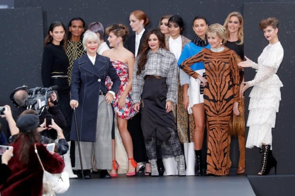 Barbara Palvin, Helen Mirren, and Jane Fonda pose with models after presenting creations on a giant catwalk on the Champs Elysees avenue during a public event by L'Oreal as part of Paris Fashion Week. Photo: REUTERS