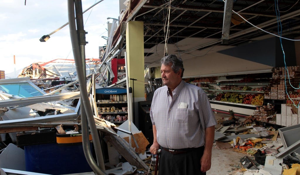 A supermarket owner stands at his destroyed business in Carolina, Puerto Rico. Photo: Reuters