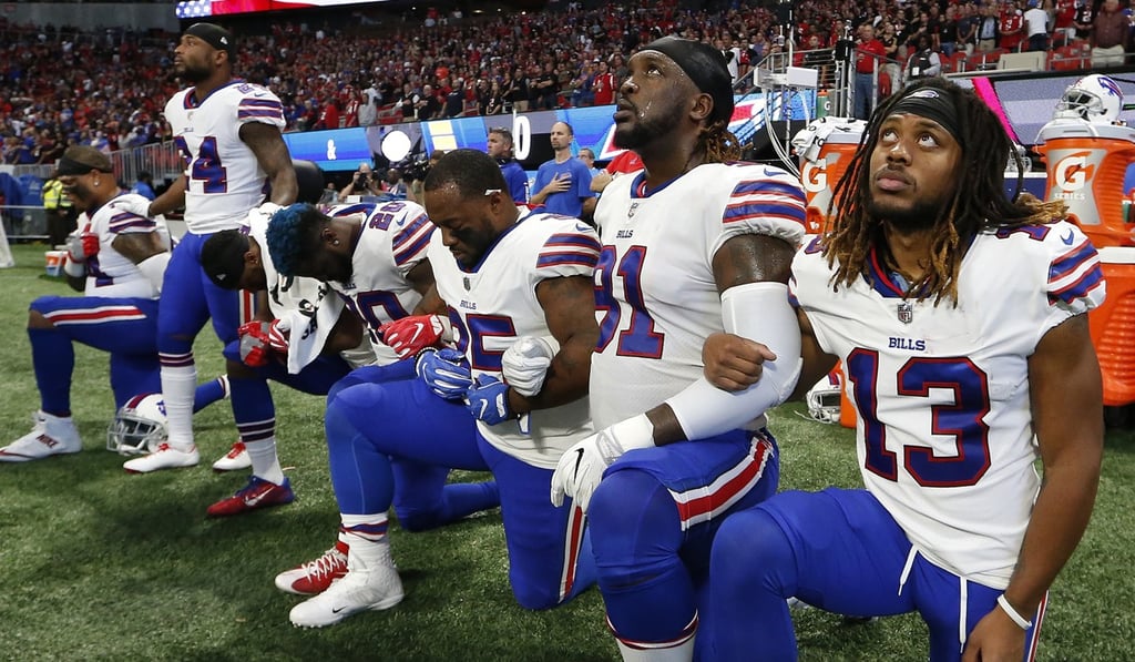 Buffalo Bills players take a knee before the first half of their game against the Atlanta Falcons. Photo: AP