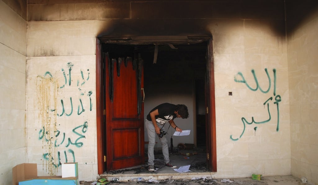 In this file photo taken on September 12, 2012, a man looks at documents at the charred US Consulate in Benghazi, Libya, the day after an attack that killed four Americans, including ambassador Chris Stevens. Photo: AP