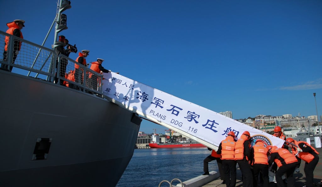 Sailors manoeuvre a gangway from the Shijiazhuang, a PLA Navy missile destroyer, following the ship's arrival in the Russian port city of Vladivostok near the North Korean border on September 18. Photo: AFP