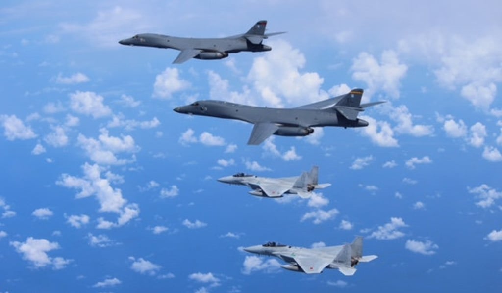 Japan's Self-Defence Forces F-15 fighter jets conduct an air exercise with US Air Force B-1B Lancer bombers flying from Andersen Air Force Base, Guam, in the skies above the East China Sea, Japan. Photo: Reuters