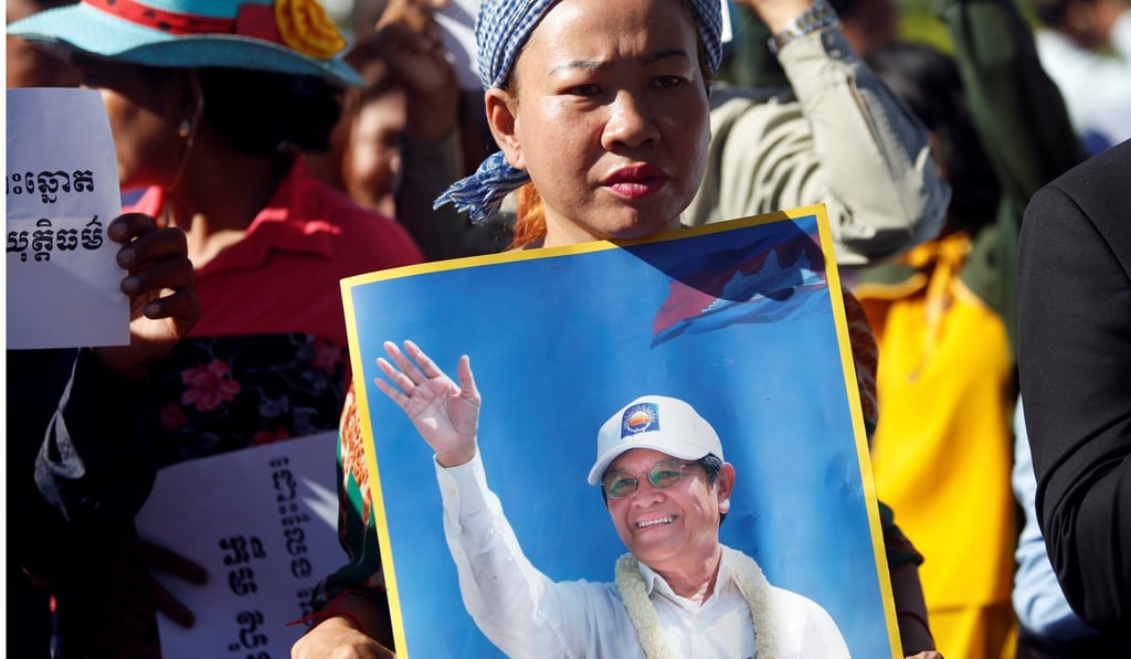Supporters of Kem Sokha, leader of the Cambodia National Rescue Party, hold photos of the jailed opposition leader during a demonstration outside the appeal court as a bail hearing took place inside. Photo: Reuters