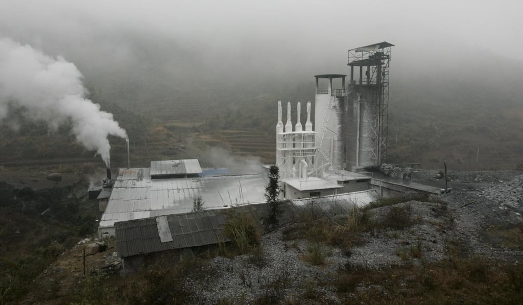 Smoke belches from a cement factory in China’s Guangdong province. Small, privately owned plants are struggling to compete against state-owned giants. Photo: EPA