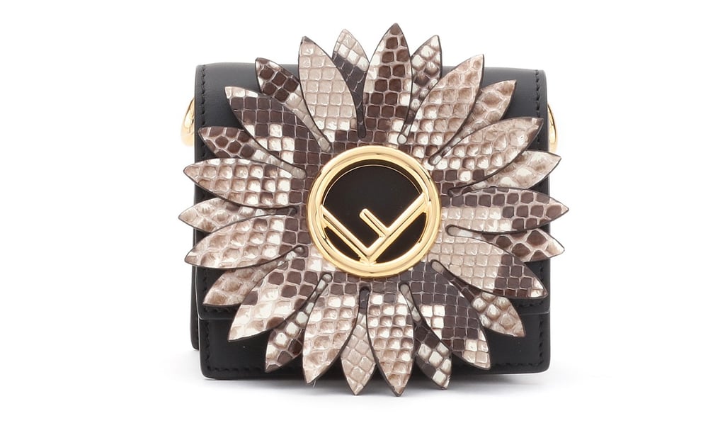 This leather shoulder bag with a python cutout daisy motif features the signature “F” logo at the centre.