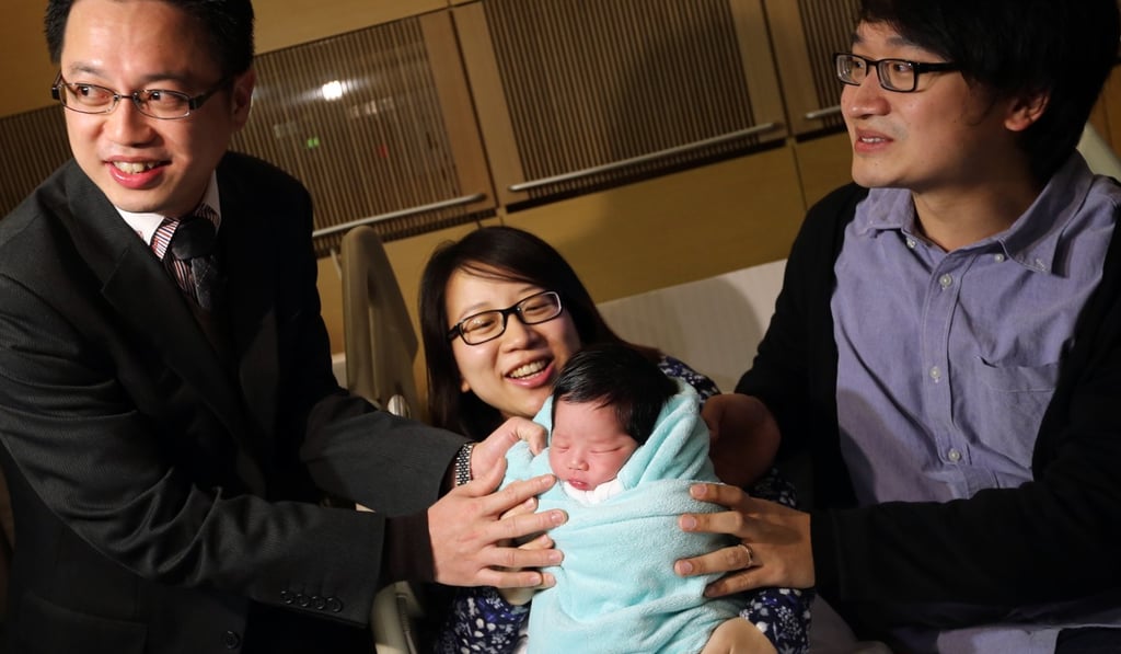 Dr Stephen Suen Sik-hung joins new mother Karen Yim Wai-ling, her husband Henry Ling Wai-hang and their baby in Union Hospital, a private facility in Sha Tin, in January 2014. Photo: David Wong