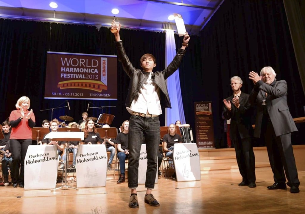 Lo celebrates after being named as the youngest harmonica world champion in Trossingen, Germany, in 2013.
