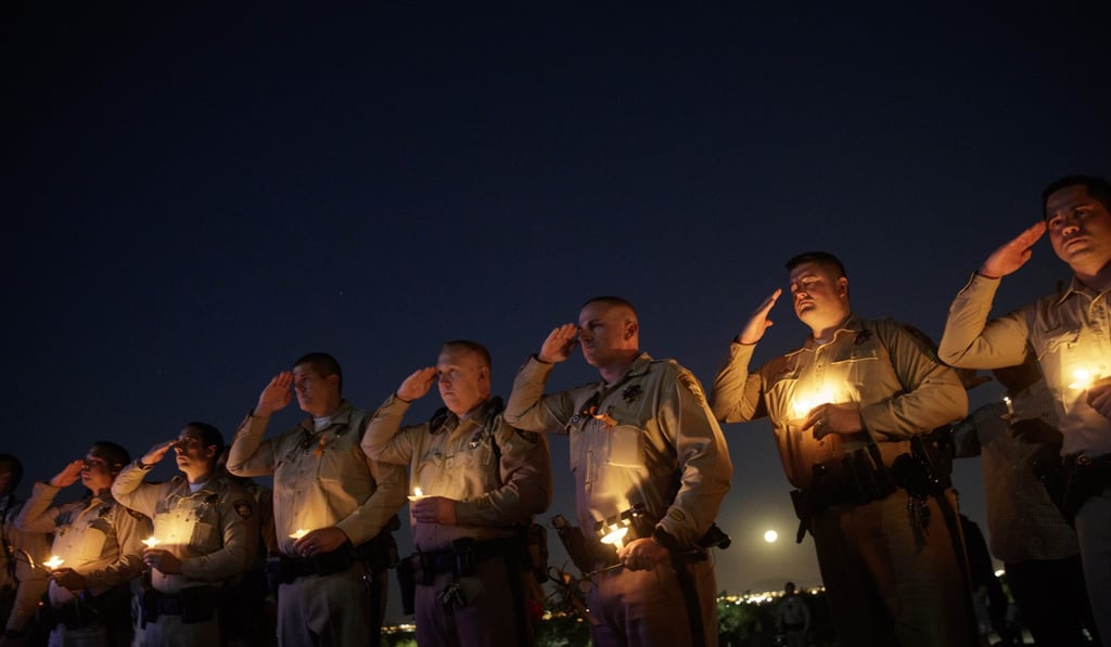 Police officer colleagues of Las Vegas police officer Charleston Hartfield salute at a memorial in his honour on Thursday. Hartfield was killed in the Las Vegas mass shooting. Photo: AFP Police officer colleagues of Las Vegas police officer Charleston Hartfield salute at a memorial in his honour on Thursday. Hartfield was killed in the Las Vegas mass shooting. Photo: AFP