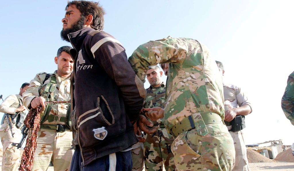 Kurdish Peshmerga forces detain Islamic State militants outside Hawija on Thursday. Photo: Reuters