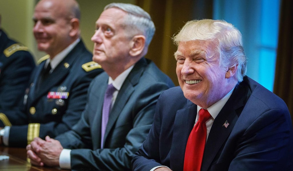 US President Donald Trump smiles as Defence Secretary James Mattis (centre) looks on during a meeting with senior military leaders in the Cabinet Room of the White House on Thursday. Photo: AFP