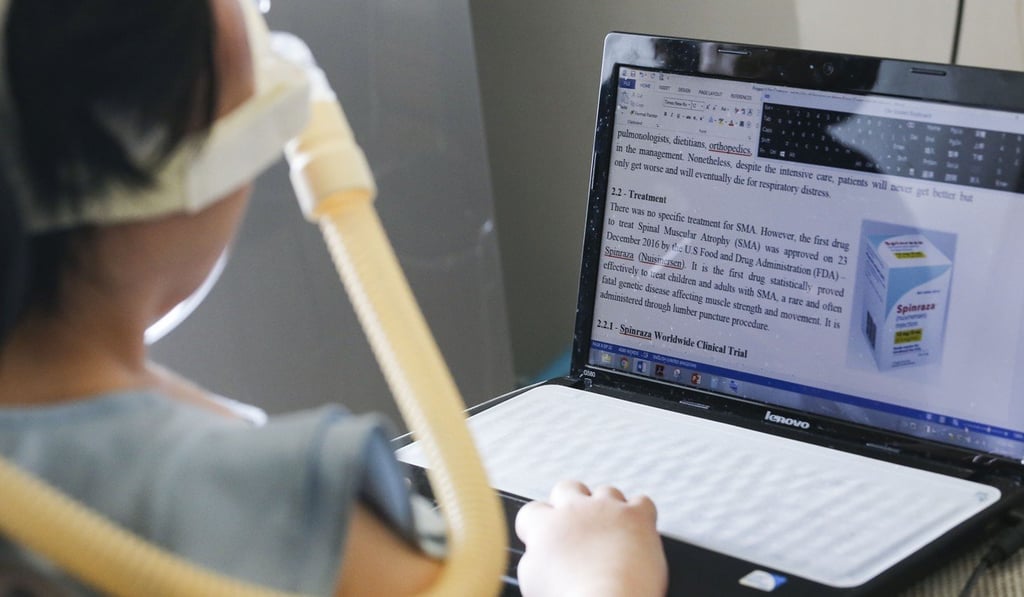 Josy Chow types with a special pad on her laptop. Photo: Felix Wong