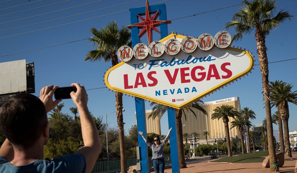 People pose for photos by the Welcome to Fabulous Las Vegas sign just south of the Mandalay Bay Resort and Casino. Photo: AFP People pose for photos by the Welcome to Fabulous Las Vegas sign just south of the Mandalay Bay Resort and Casino. Photo: AFP
