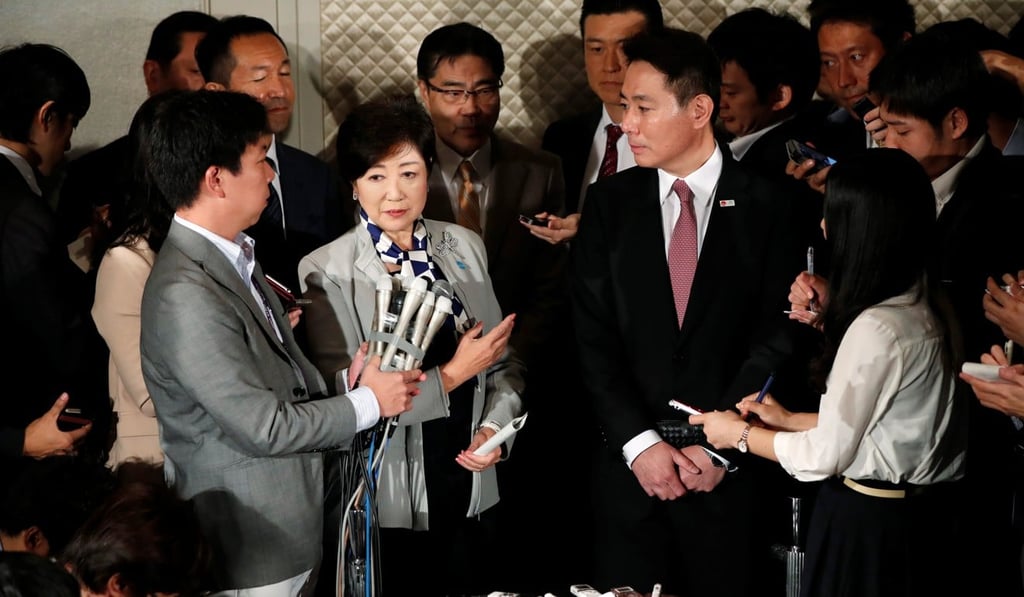Koike and Democratic Party leader Seiji Maehara surrounded by the media at a news conference after their talks in Tokyo on October 5, 2017. Photo: Reuters