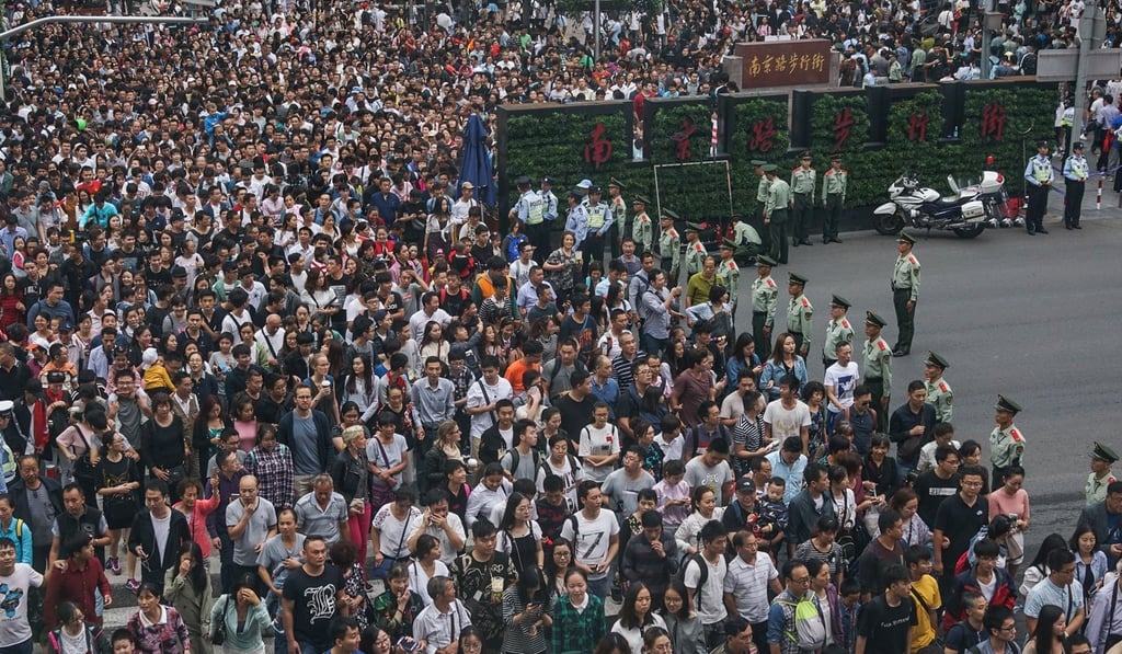 Security personnel keep watch at a pedestrian crossing in Shanghai during the week-long holiday. Photo: AFP Security personnel keep watch at a pedestrian crossing in Shanghai during the week-long holiday. Photo: AFP