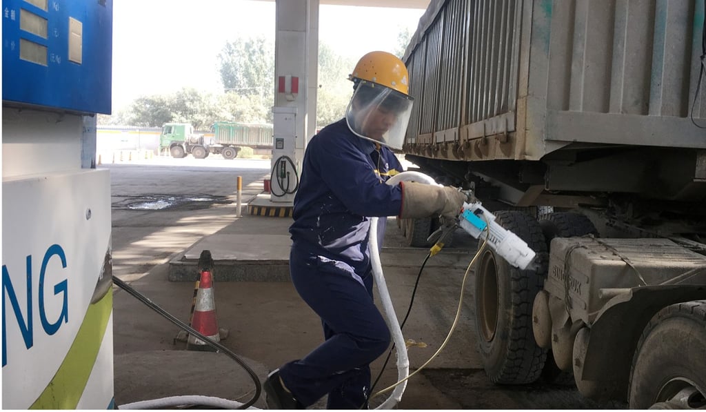 A man prepares to fuel an LNG truck at a service station in northern China. Sales of LNG heavy trucks surged 540 per cent to nearly 39,000 in the first seven months of the year, according to IHS Markit. Photo: Reuters
