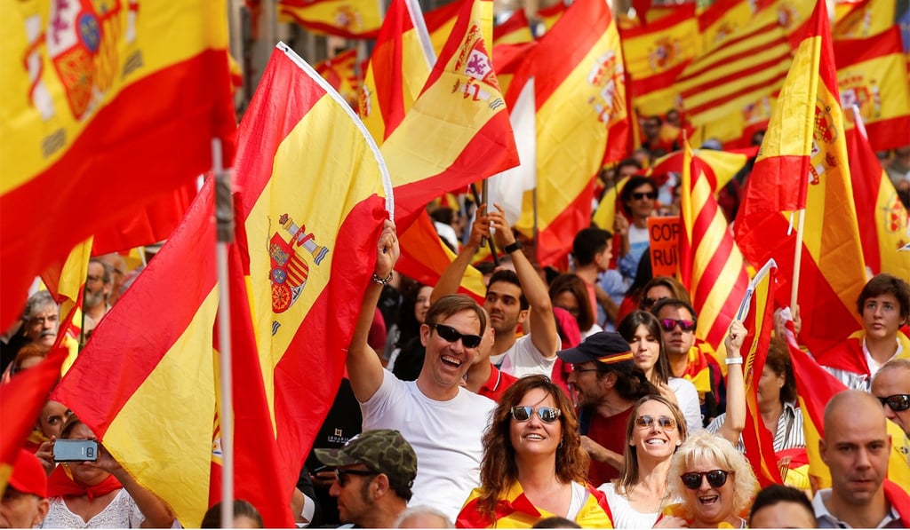 People wave Spanish and Catalan flags at a pro-union demonstration in Barcelona. Photo: Reuters