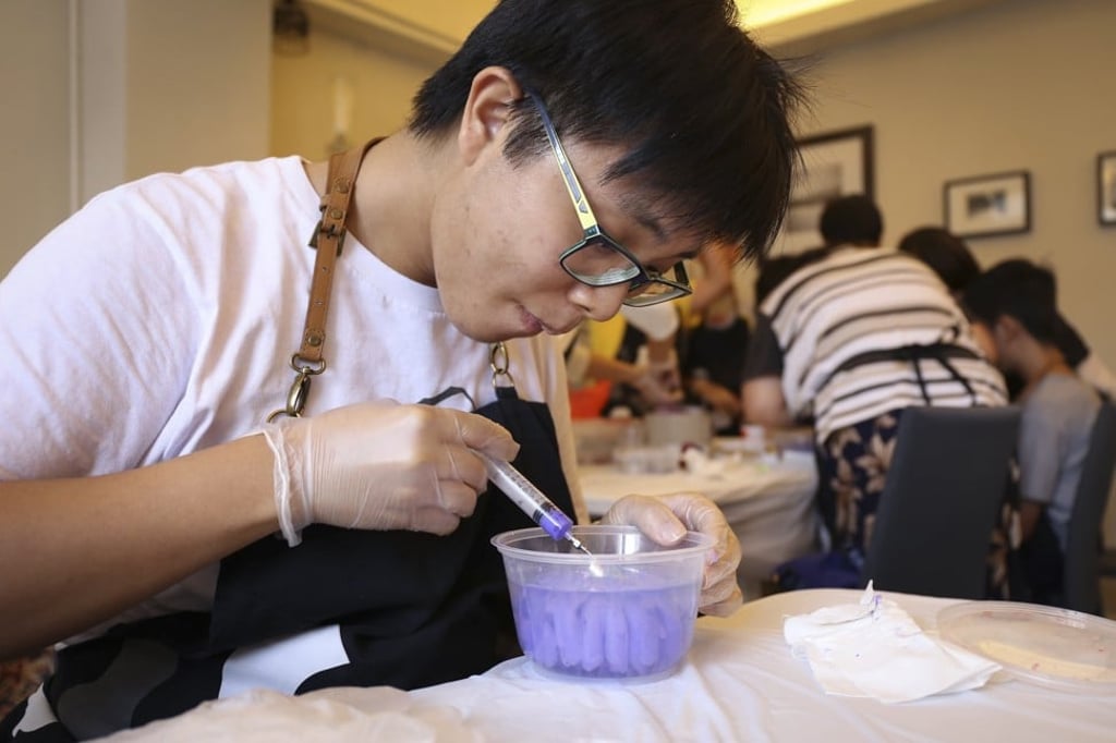 Sum, who is diagnosed with autism, creates 3D jelly art at a workshop organised by NGO LovXpress. Photo: Rachel Cheung