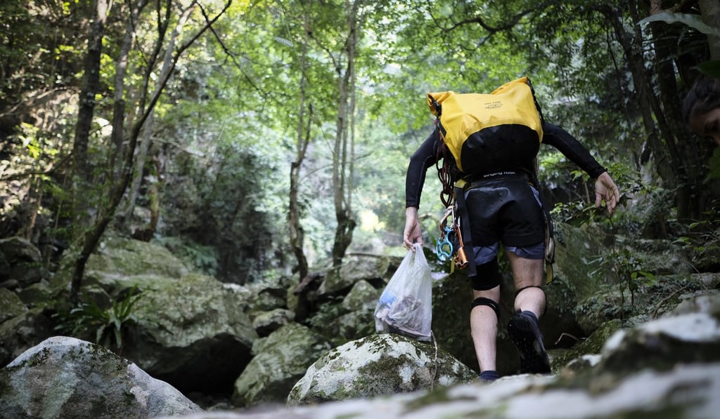 Tait collects rubbish as he goes stream trekking in the New Territories. Photo: James Wendlinger