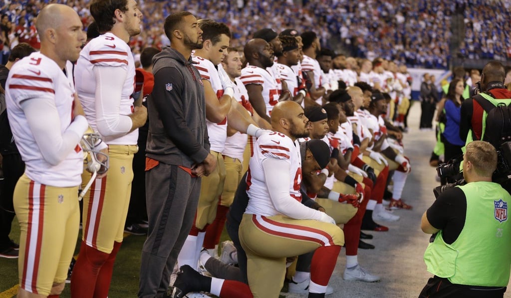 Members of the San Francisco 49ers kneel during the playing of the national anthem before an NFL football game against the Indianapolis Colts on Sunday in Indianapolis. Photo: AP