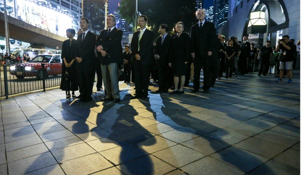 Lawyers hold a silent march in Hong Kong against the National People’s Congress Standing Committee interpretation of the Basic Law, on November 8 last year. Hong Kong’s legal system is separate from that which exists on the mainland. But the two meet when there is a need for an interpretation of the Basic Law. Photo: Sam Tsang