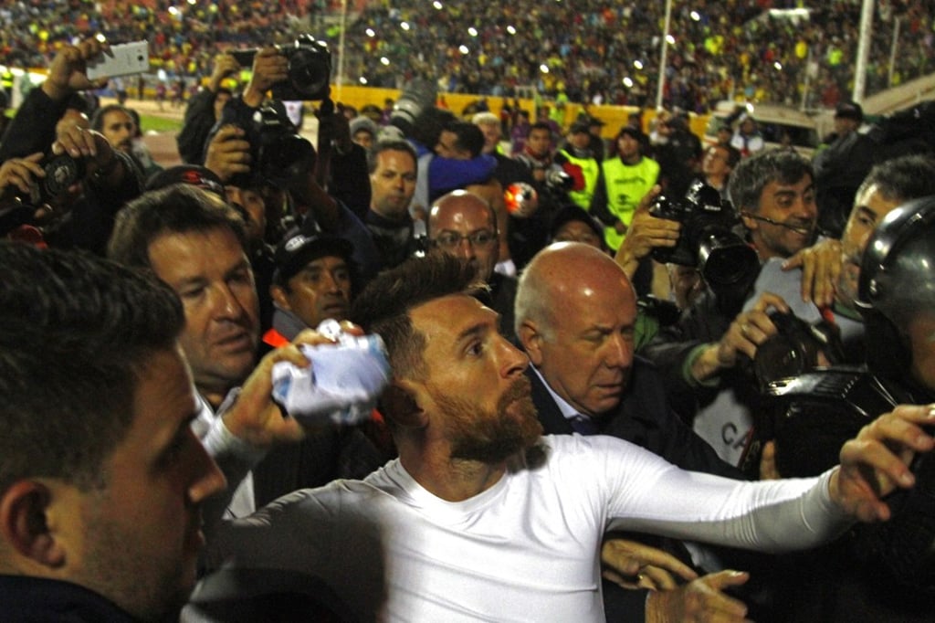 Messi throws his jersey to the crowd as he celebrates the win over Ecuador. Photo: AFP