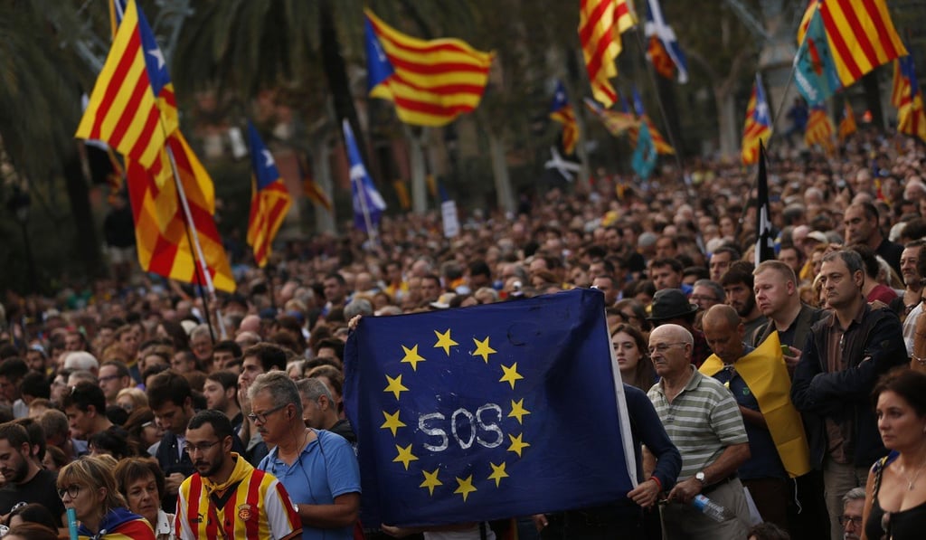 Catalan independence supporters hold a European Union flag during a rally in Barcelona on Tuesday. Phto: AP Catalan independence supporters hold a European Union flag during a rally in Barcelona on Tuesday. Phto: AP