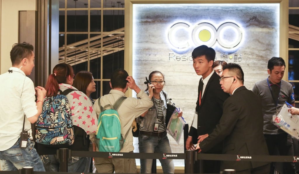 People line up at a sales office for COO Residence, a new residential project offering micro flats in Tuen Mun, at the Bank of America Tower in Central, last month. Housing is one of Carrie Lam’s priorities. Photo: David Wong